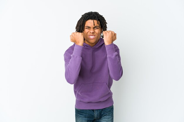 Young african american rasta man showing fist to camera, aggressive facial expression.