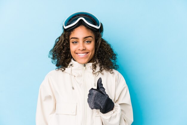 Young african american skier woman isolated smiling and raising thumb up