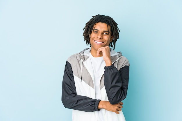 Young african american sport man smiling happy and confident, touching chin with hand.