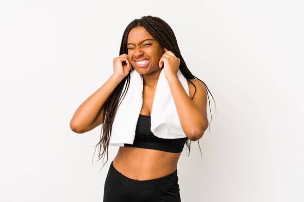 Young african american sport woman isolated covering ears with hands.