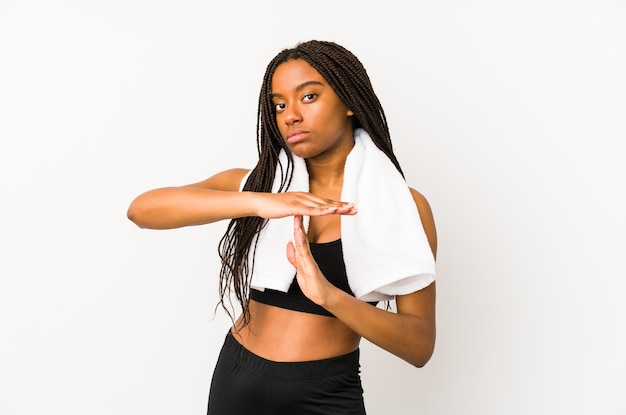 Young african american sport woman isolated showing a timeout gesture.