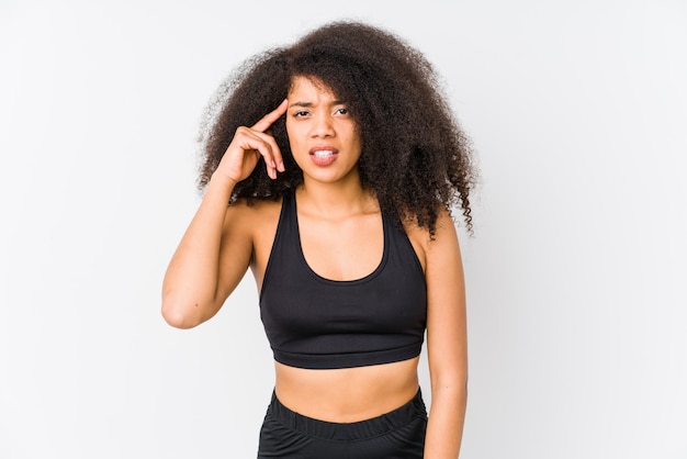 Young african american sporty woman showing a disappointment gesture with forefinger.