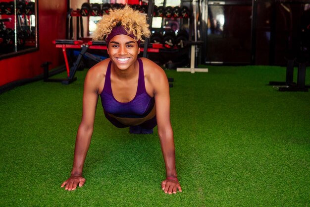 Young african american woman activity working out in gym indoor