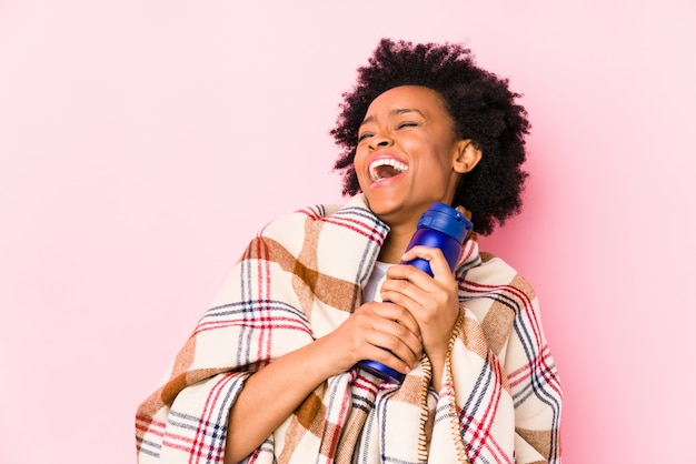 Young african american woman in a camping day isolated