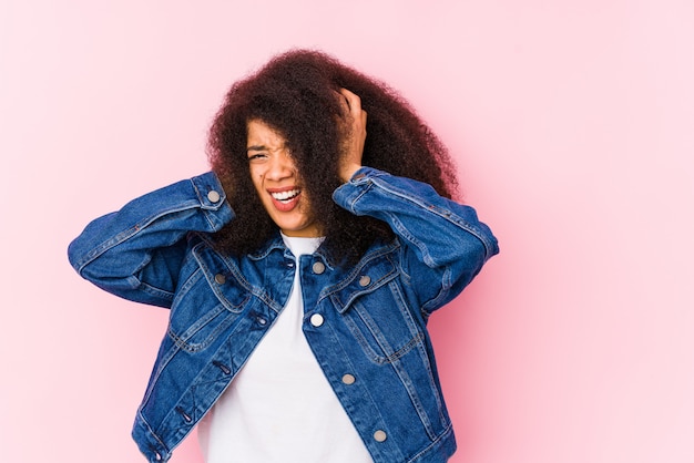 Young african american woman covering ears with hands trying not to hear too loud sound.