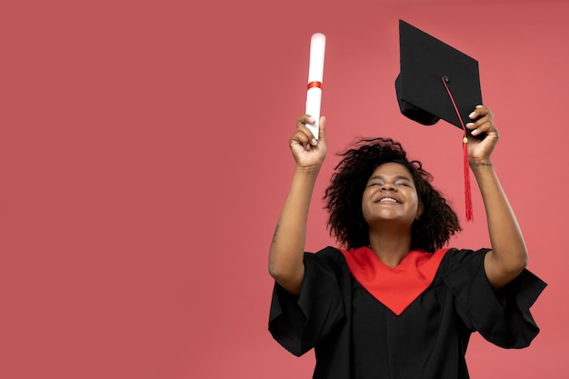 A young African American woman in a graduation uniform