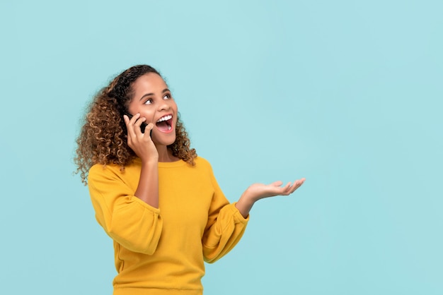 Young African American woman happily takling to the phone