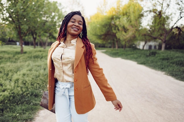 Young african american woman having a walk in a park