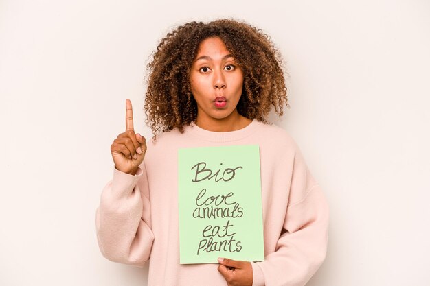 Young African American woman holding a bio placard isolated on white background having some great idea concept of creativity