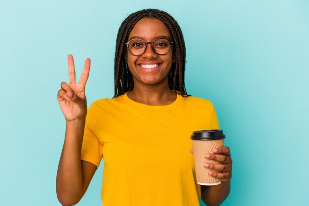 Young African American woman holding a take away coffee isolated on blue background  showing number two with fingers.