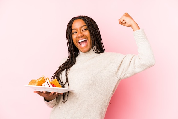 Young african american woman holding a waffle