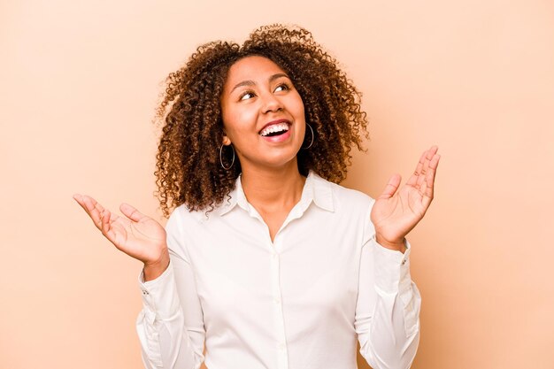 Young African American woman isolated on beige background joyful laughing a lot Happiness concept