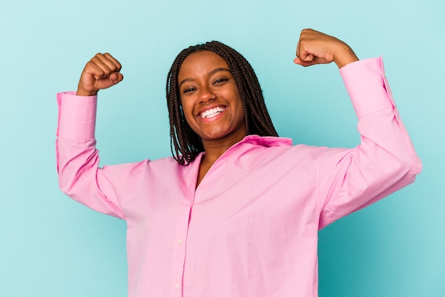 Young african american woman isolated on blue background  cheering carefree and excited. Victory concept.