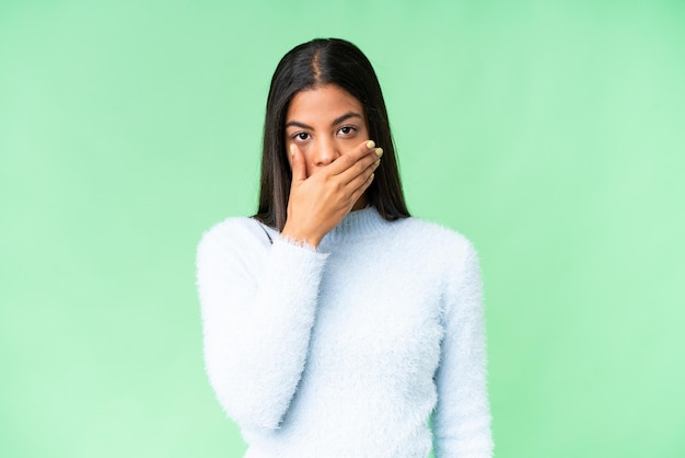 Young African American woman over isolated chroma key background covering mouth with hand