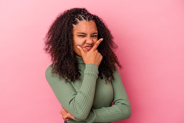 Young african american woman isolated on pink background contemplating, planning a strategy, thinking about the way of a business.