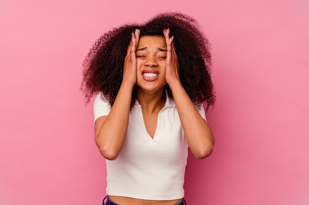 Young african american woman isolated on pink background whining and crying disconsolately.