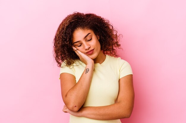 Young african american woman isolated on pink wall who is bored, fatigued and need a relax day