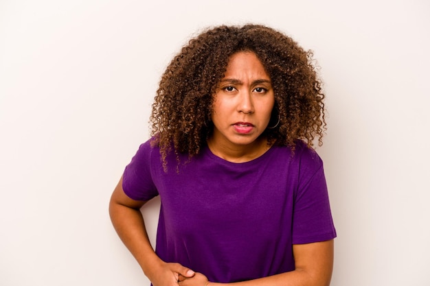 Young African American woman isolated on white background having a liver pain stomach ache