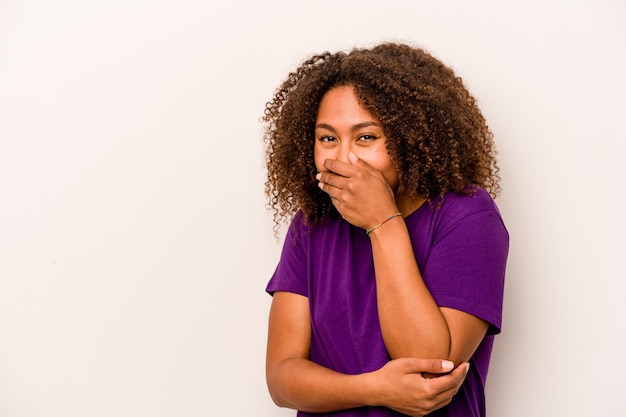 Young African American woman isolated on white background laughing happy carefree natural emotion