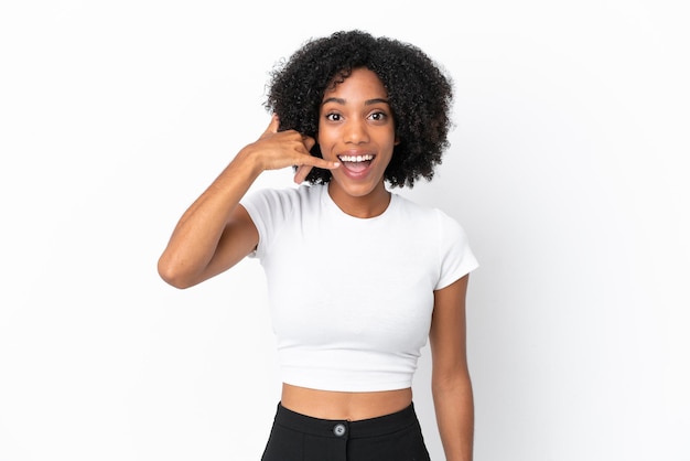 Young African American woman isolated on white background making phone gesture. Call me back sign