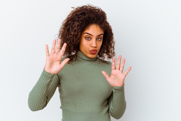 Young african american woman isolated on white background rejecting someone showing a gesture of disgust.