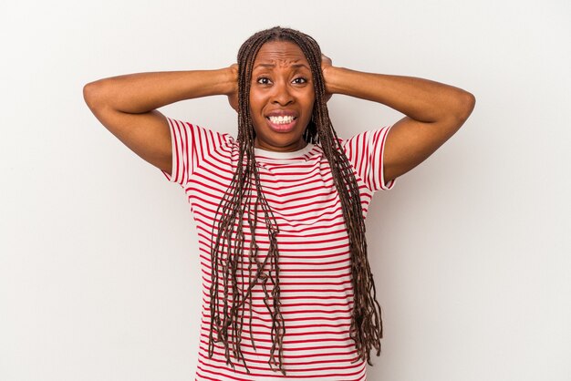 Young african american woman isolated on white background screaming with rage.