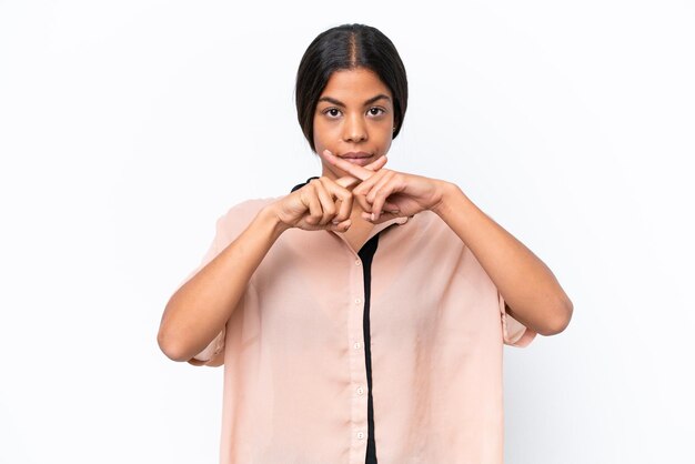 Young African american woman isolated on white background showing a sign of silence gesture