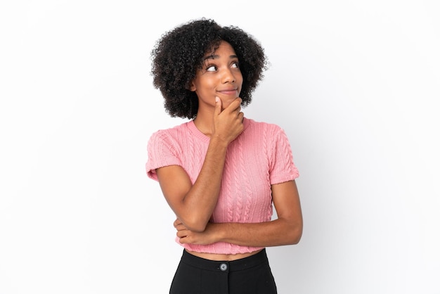 Young African American woman isolated on white background thinking an idea while looking up