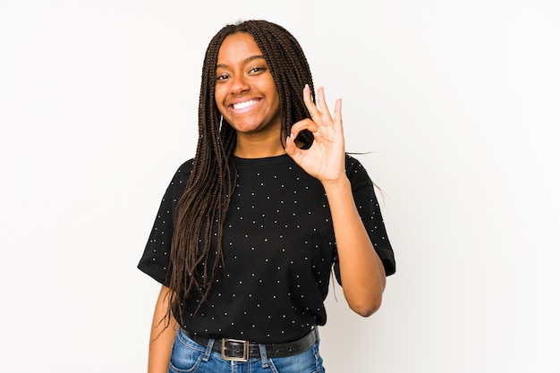 Photo young african american woman isolated on white wall cheerful and confident showing ok gesture.