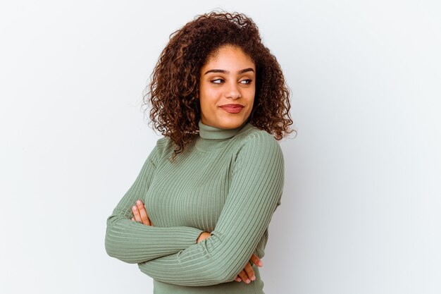 Young african american woman isolated on white wall laughing and having fun.