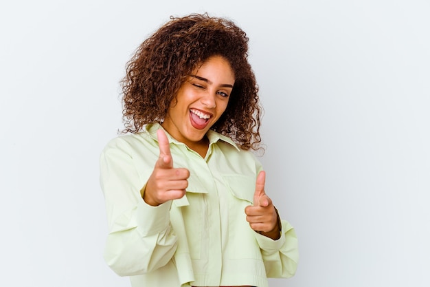 Young african american woman isolated on white wall pointing to front with fingers.