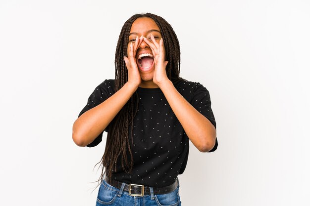 Young african american woman isolated on white wall shouting excited to front.