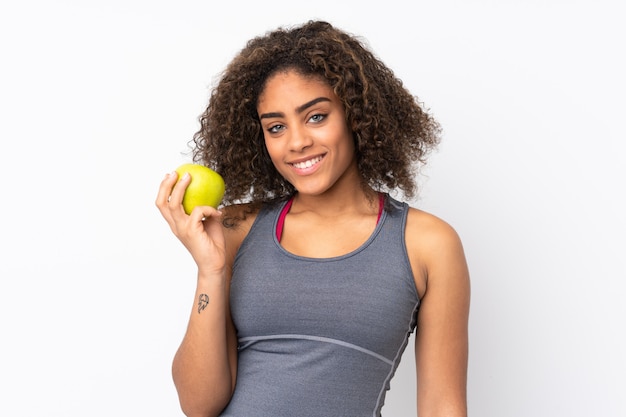 Young African American woman isolated on white with an apple