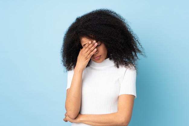 Young african american woman over isolated with headache