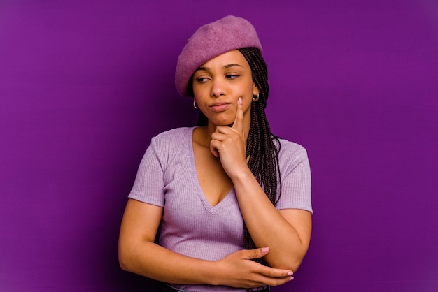 Young african american woman isolated on yellow background Young african american woman isolated on yellow background contemplating, planning a strategy, thinking about the way of a business.