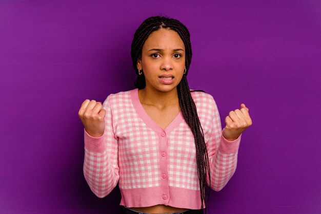 Young african american woman isolated on yellow wall showing that she has no money