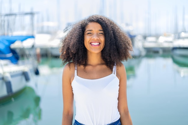 Young African American woman at outdoors With happy expression