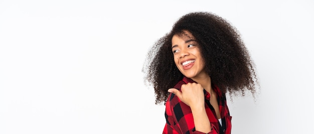 Young african american woman pointing to the side to present a product