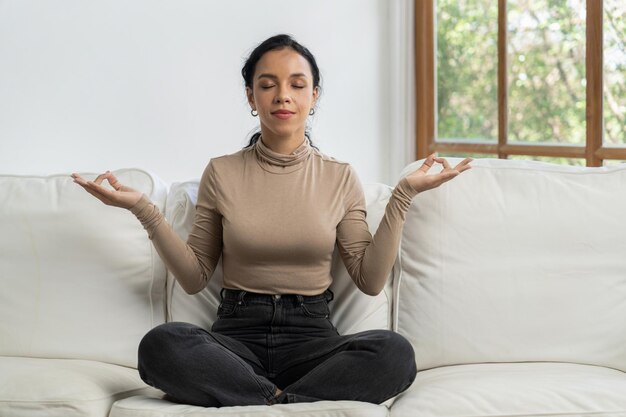 Young African American woman practice crucial mindful meditation at home