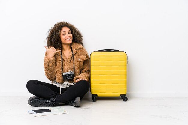 Young african american woman ready for a travel showing a mobile phone call gesture with fingers.