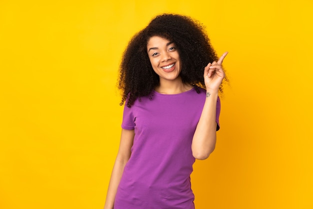 Young african american woman showing and lifting a finger in sign of the best