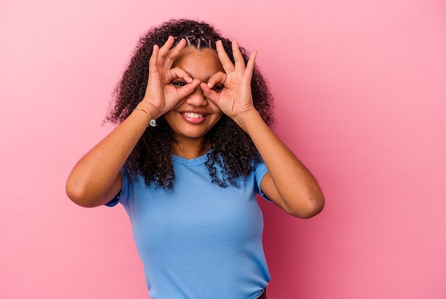 Young african american woman  showing okay sign over eyes