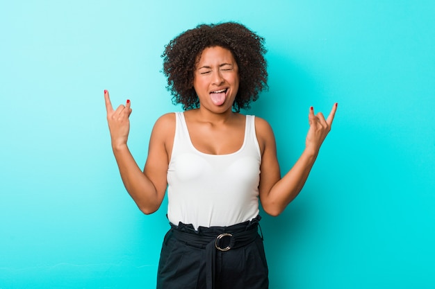 Young african american woman showing rock gesture with fingers