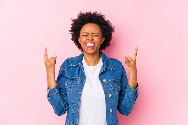 Young african american woman showing rock gesture with fingers