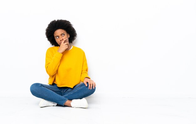 Young African American woman sitting on the floor