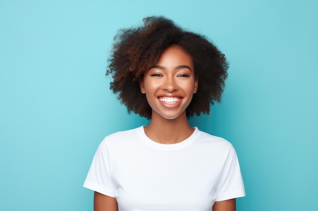 Young African American woman smiling and wearing a white tshirt on a turquoise background