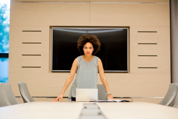 Young african american woman standing in a modern office