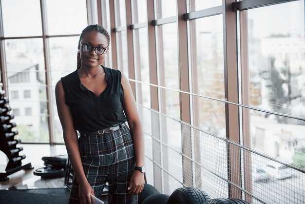 A young African American woman in stylish clothes.