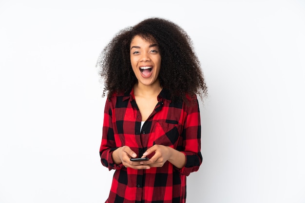 Young african american woman surprised and sending a message