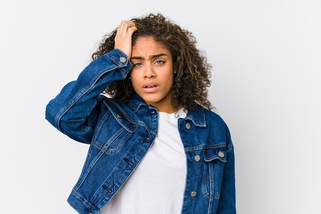 Young african american woman tired and very sleepy keeping hand on head.